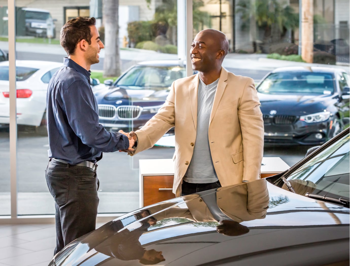 BMWHero.jpg smiling man shaking hands with a bmw salesman